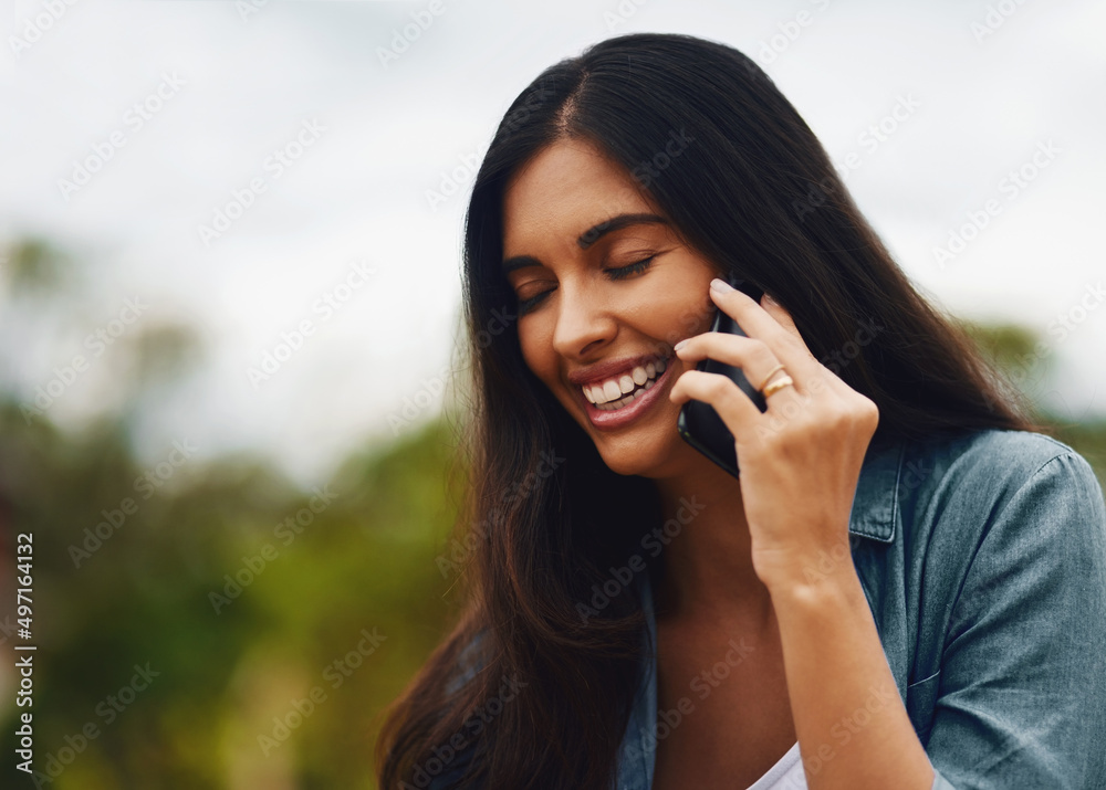 Hey, Im so happy you called. Shot of an attractive young woman using a mobile phone in a park. Hey, Im so happy you called. Shot of an attractive young woman using a mobile phone in a park.