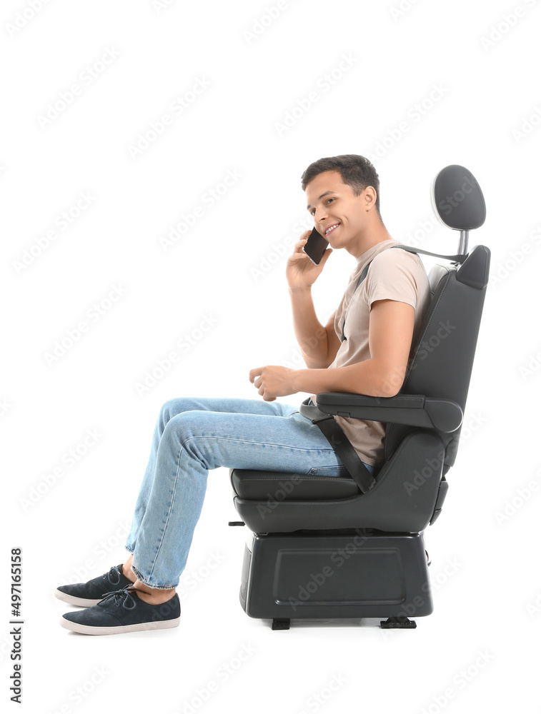 Young man talking by mobile phone in car seat on white background Young man talking by mobile phone in car seat on white background