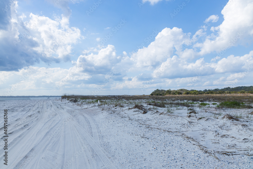 Sand beach and blue sky with white clouds