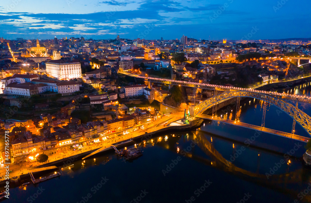 Picturesque view from drone of city of Porto and Dom Luis Bridge at night, Portugal