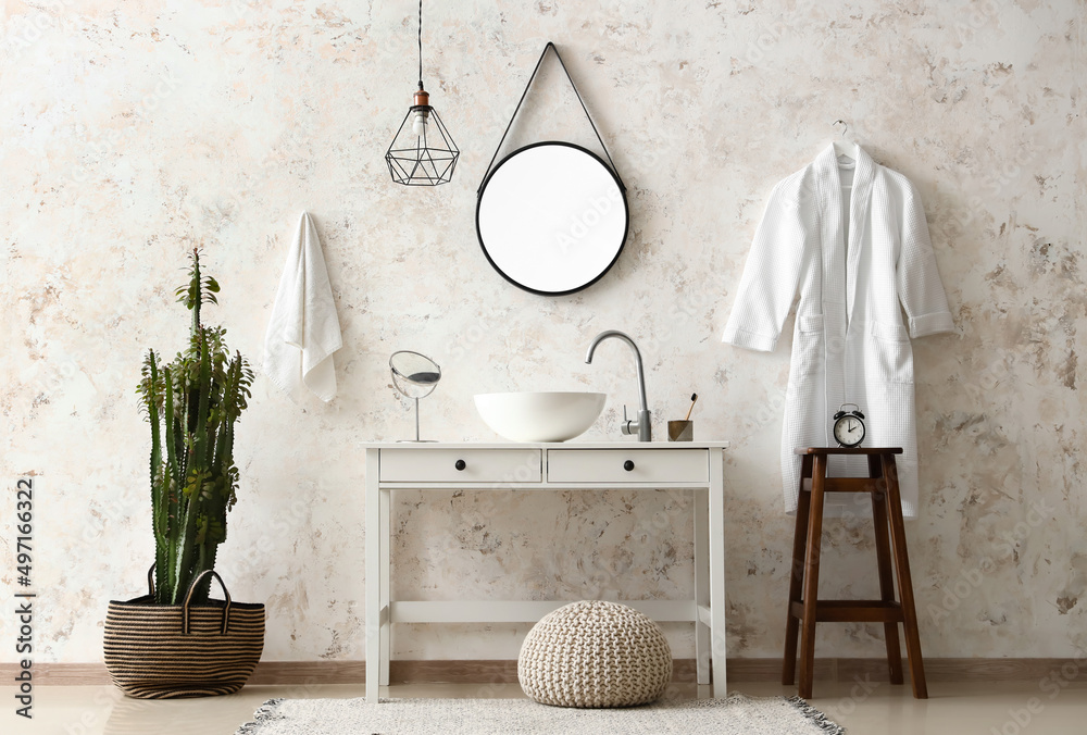 Obraz premium Interior of light room with sink, cactus and bathrobe