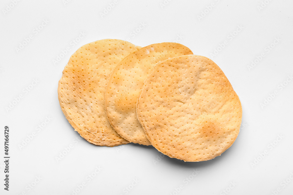 Round Jewish flatbread matza for Passover on white background Round Jewish flatbread matza for Passover on white background