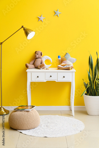 Table with baby clothes, to...