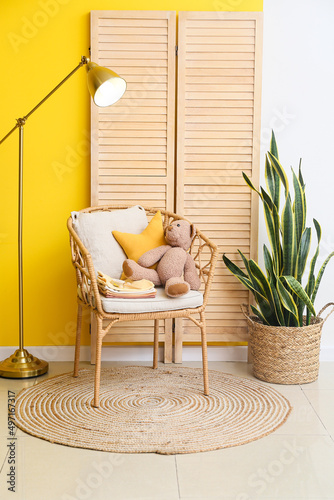 Armchair with baby clothes,...