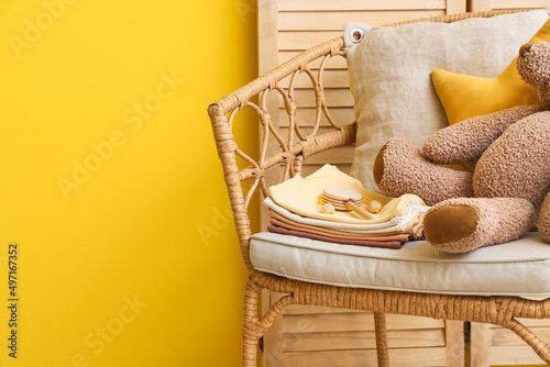 Armchair with baby clothes ...