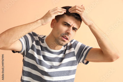 Worried young man with hair...