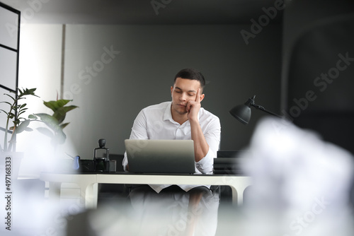 Tired young businessman wor...