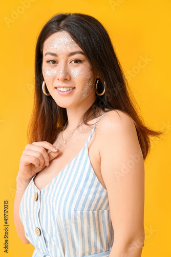 Smiling Asian woman with gl...
