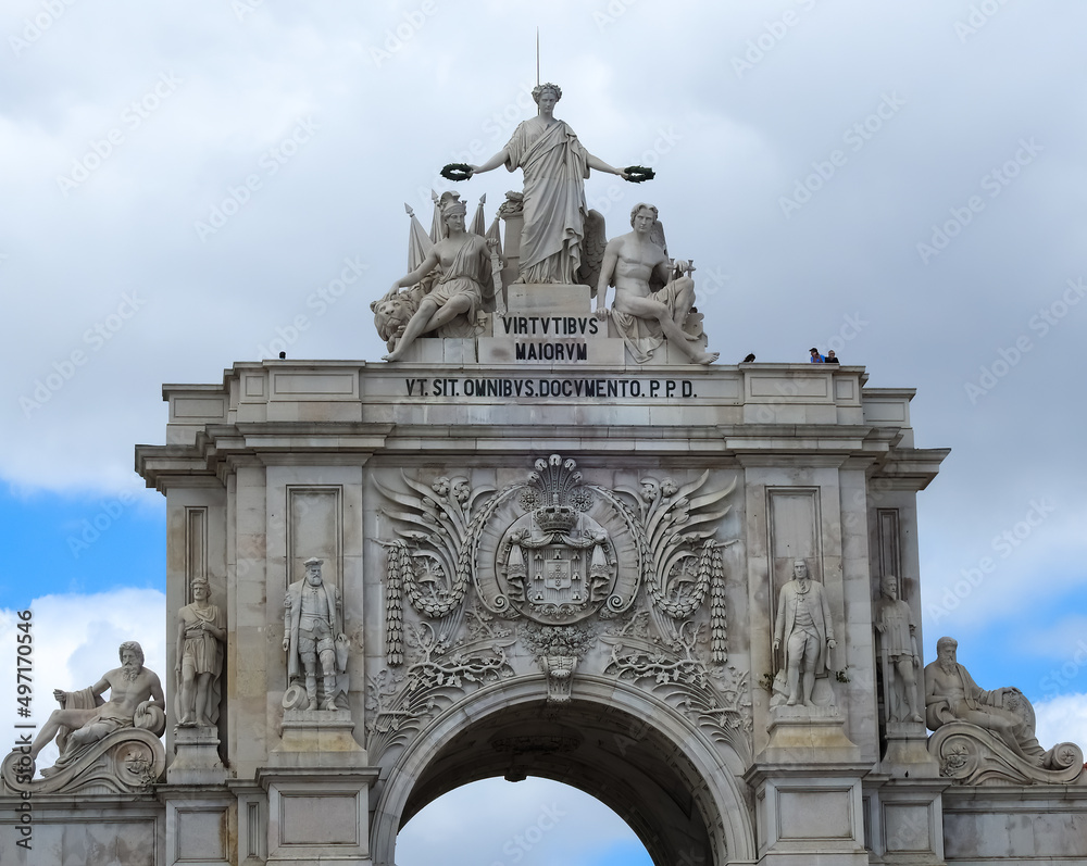 Lisbon, Portugal - June 19 2019: statues and portico (arc of triumph) at Praca do Comercio, center of Lisbon.