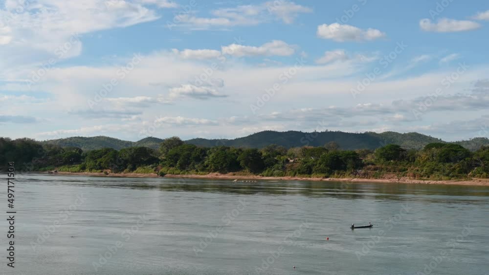 A fishing boat drifting with the current in Mekong River, Thailand and Laos. A fishing boat drifting with the current in Mekong River, Thailand and Laos.