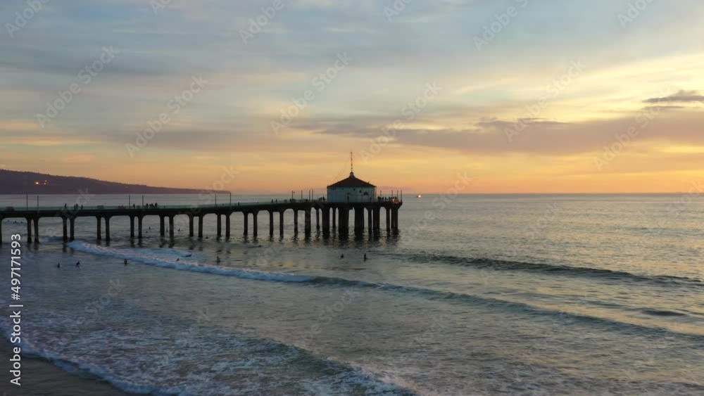 People Swim At The Manhattan Beach With Roundhouse Aquarium On Pier At Dusk. - aerial People Swim At The Manhattan Beach With Roundhouse Aquarium On Pier At Dusk. - aerial