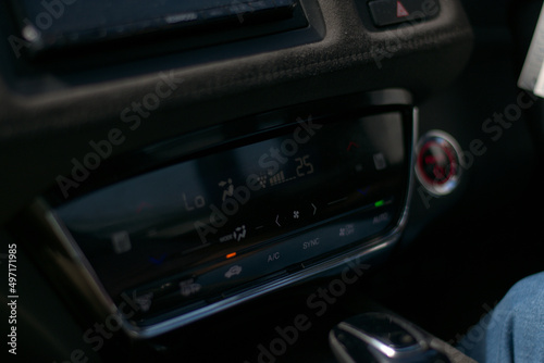 hybrid electric car dashboard climate control system with capacitive touch LED display, temperature controls, fan speed controls, airflow, air circulation  infotainment display. © Pulasthi Keragala