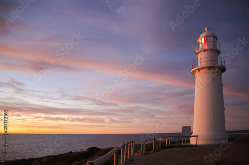 Lighthouse at sunset at the sea coast