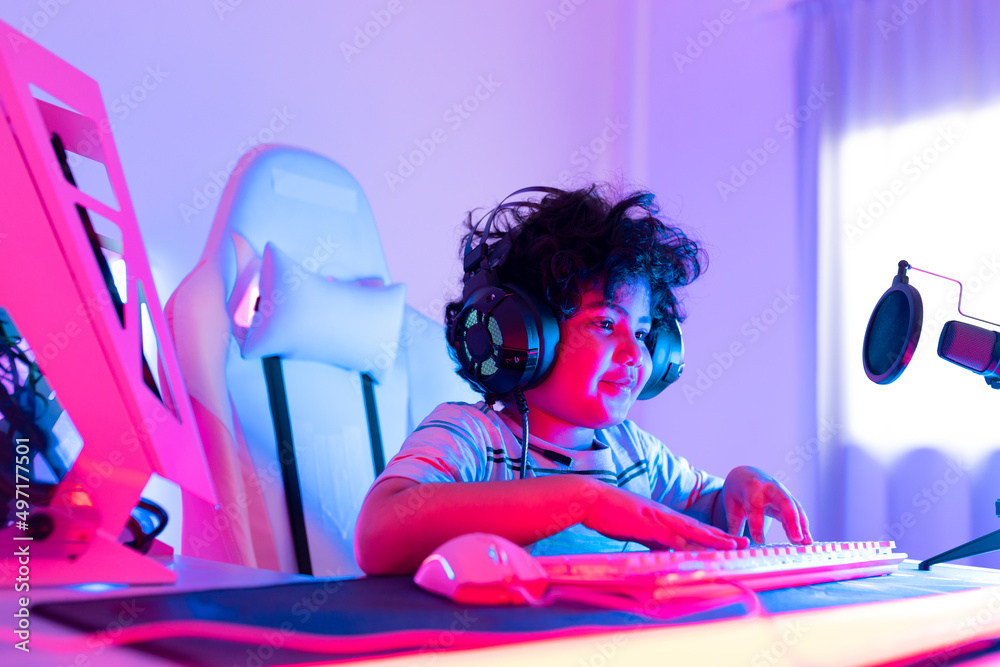 young playing game online at home. Gamer controlling joystick for video game. Teenage girls leisure game in neon light room at home. young playing game online at home. Gamer controlling joystick for video game. Teenage girls leisure game in neon light room at home.