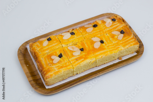 Lekkker Holland cake served with slices. The cake's real name is Dutch Buttercake or Boterkoek. photo