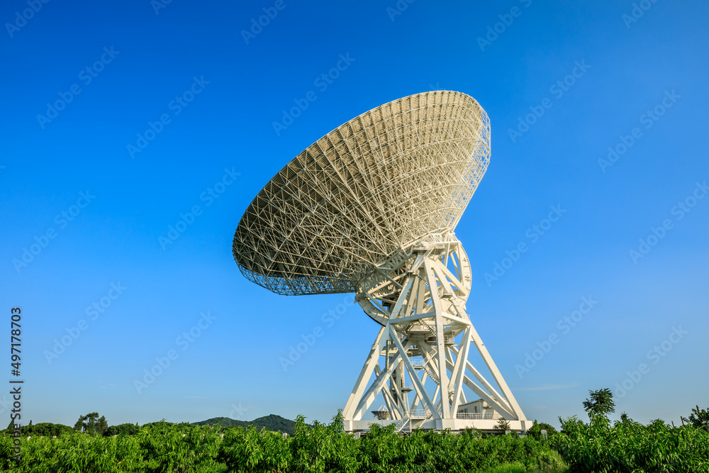 Astronomical radio telescope under blue sky