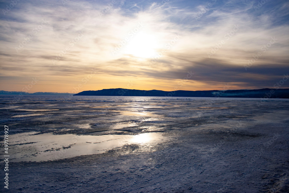 View of the frozen lake. Nature of Russia, Siberia. Lake Baikal. It's cold. Winter sunset.