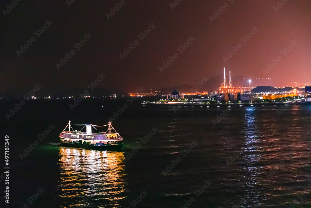 Ferry passing victoria harbour at night, Hong Kong