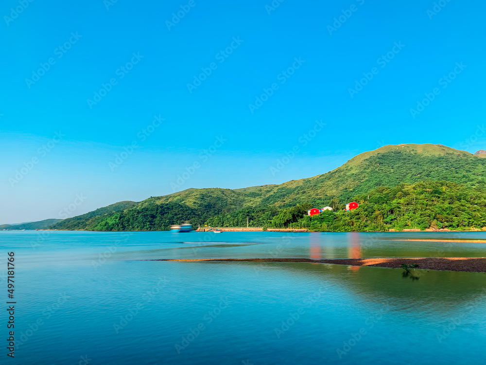 Fototapeta premium Red house next to the sea, countryside, sai kung, hong kong, autumn