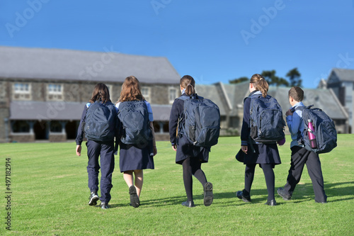 School students group walking together to school