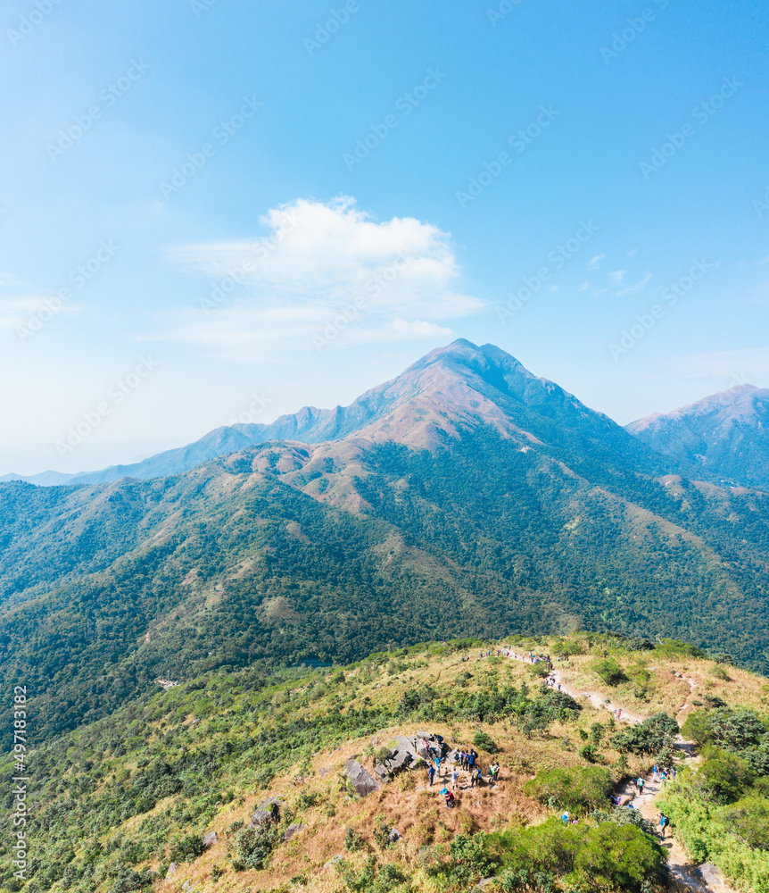Fototapeta premium Many people hiking on the path to the famos location, Sunset Peak, Lantau Island, Hong Kong