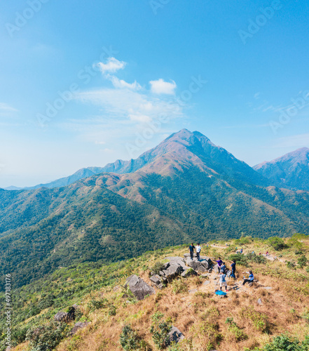 Many people hiking on the path to the famos location, Sunset Peak, Lantau Island, Hong Kong