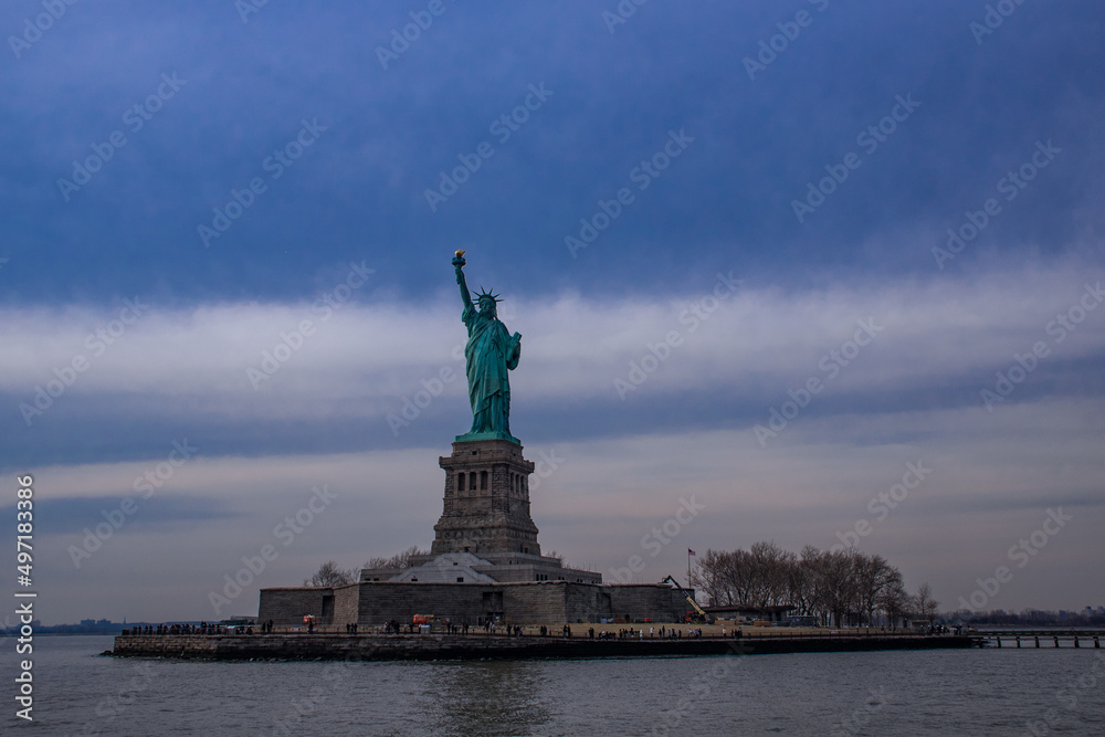 The Statue of Liberty against a blue sky at daytime