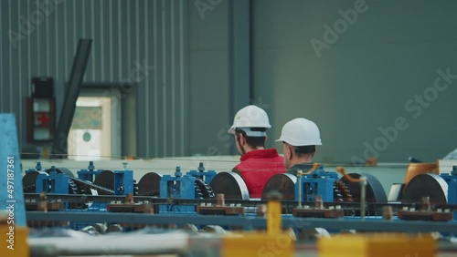 Wallpaper Mural Close up shot back two men engineers in safety uniform and hard hat walking in factory. Inspector in warehouse. Torontodigital.ca