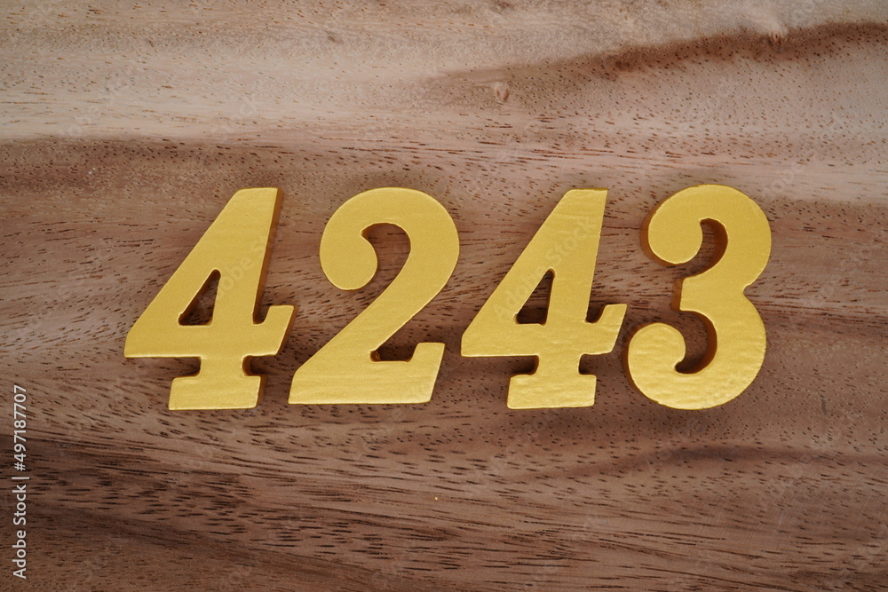 Golden Arabic numerals on a real brown and white wooden floor number ...