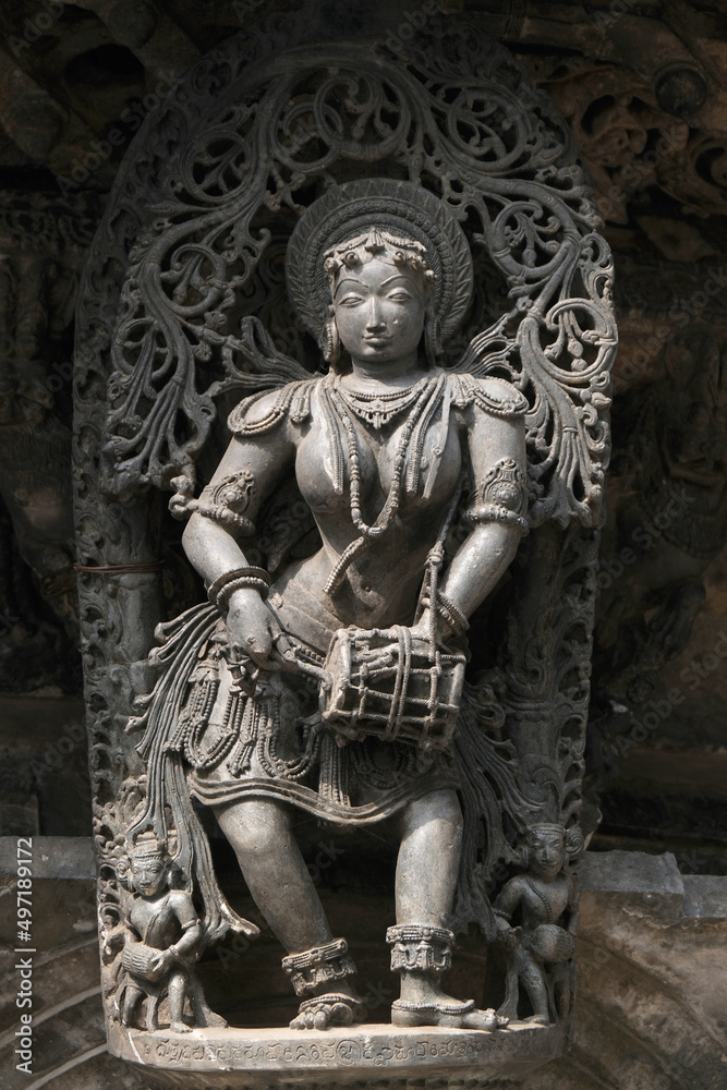 Stone Sculpture of Beautiful Female (Madanikas) with selective focus, 12th century Hindu temple, Ancient stone art and sculptures in each pillars, Chennakeshava Temple, Belur, Karnataka, India.