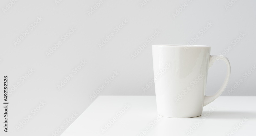 Fototapeta premium One white ceramic cups on the table