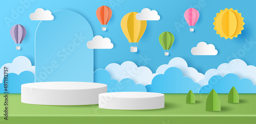 Paper cut of Summer season on green nature landscape, hot air balloons, sun and clouds on blue sky background with white color cylinder podium for your products display presentation