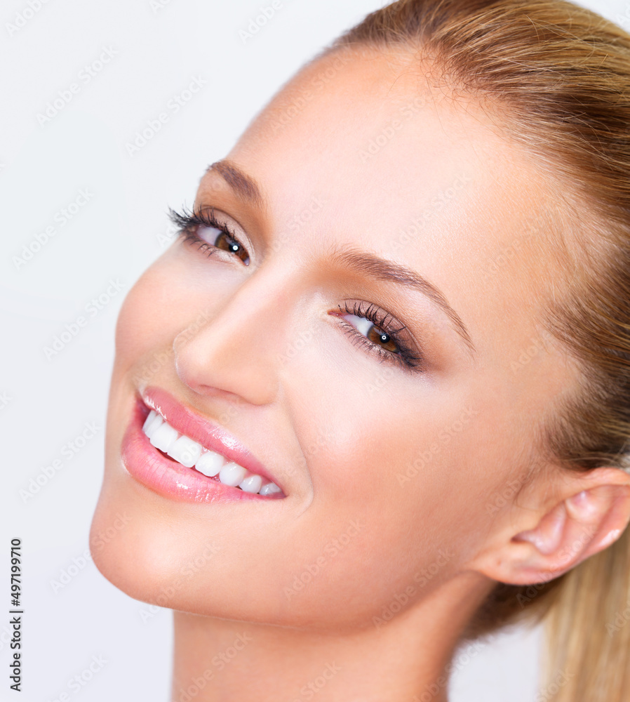 Simply luminous beauty with a beguiling smile. Cropped closeup of a naturally beautiful woman with flawless skin smiling at you, isolated on white. Simply luminous beauty with a beguiling smile. Cropped closeup of a naturally beautiful woman with flawless skin smiling at you, isolated on white.