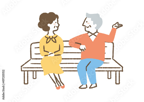 ベンチに座って話す高齢夫婦_色