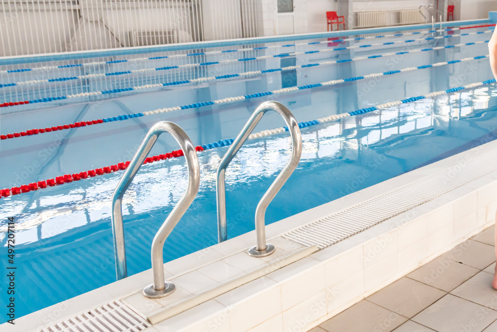 Swimming pool with clean water in the sports complex for athletes young and old. Swimming pool with clean water in the sports complex for athletes young and old.