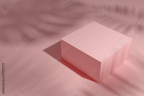 Podium for placing inserted objects. A pink scene with a pink cube. Shadows from palm leaves on stage. 3D render. photo