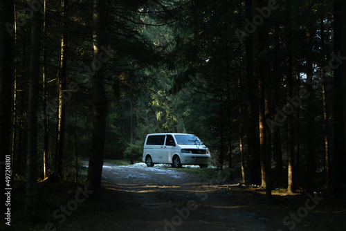 Minivan car in forest in Carpathian mountains