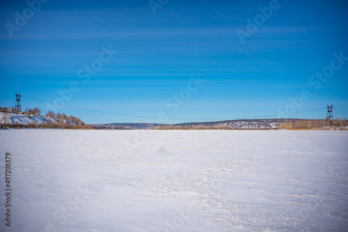 Winter view on the frozen river Tom in the vicinity of the Siberian city of Kemerovo