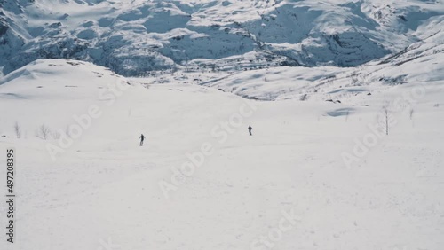 Skier flies by at full speed down snowy slope in Norway, Vatnahalsen. Handheld view photo