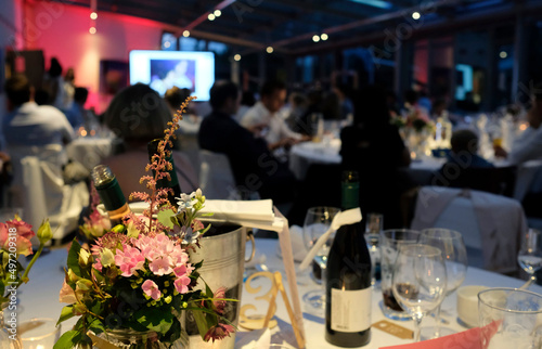 Evening event with flowers and wine bottles on the tables