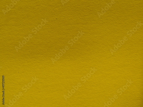 Abstract background made of green-yellow paper. Close-up, paper texture. Yellow-green cardboard close-up-textured paper background. Abstract background made of thick swamp-colored paper