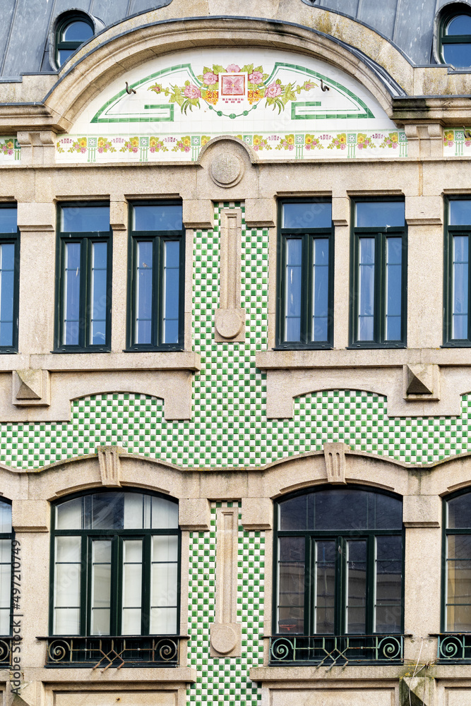 colorful azulejos on an old granite facade in Porto, Portugal