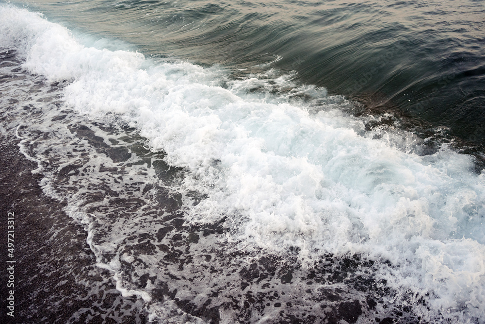 Dark sand and foamy wave background. Natural Seaside texture Dark sand and foamy wave background. Natural Seaside texture