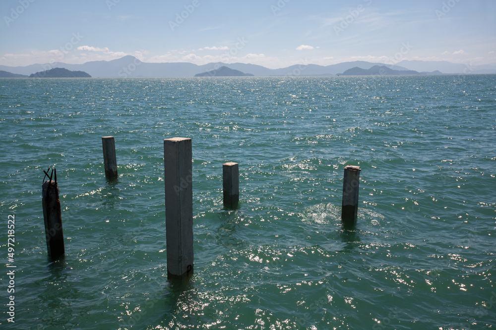 Ruins of concrete pole in the sea