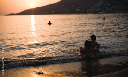 Family holiday on the coast of Greece is idyllic, disconnect from the hustle and bustle of city life and re-connect with my loved ones. Young children enjoy the coast of Greece in the sunlight sunset