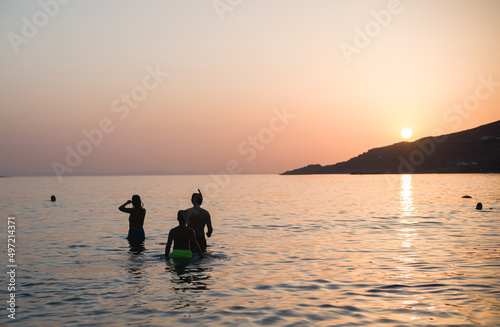 Family holiday on the coast of Greece is idyllic, disconnect from the hustle and bustle of city life and re-connect with my loved ones. Young children enjoy the coast of Greece in the sunlight sunset © Damian