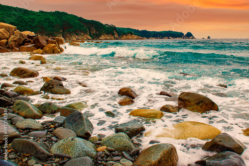 coastline, beautiful beach stones and blue waves. lots of sun and beautiful nature.