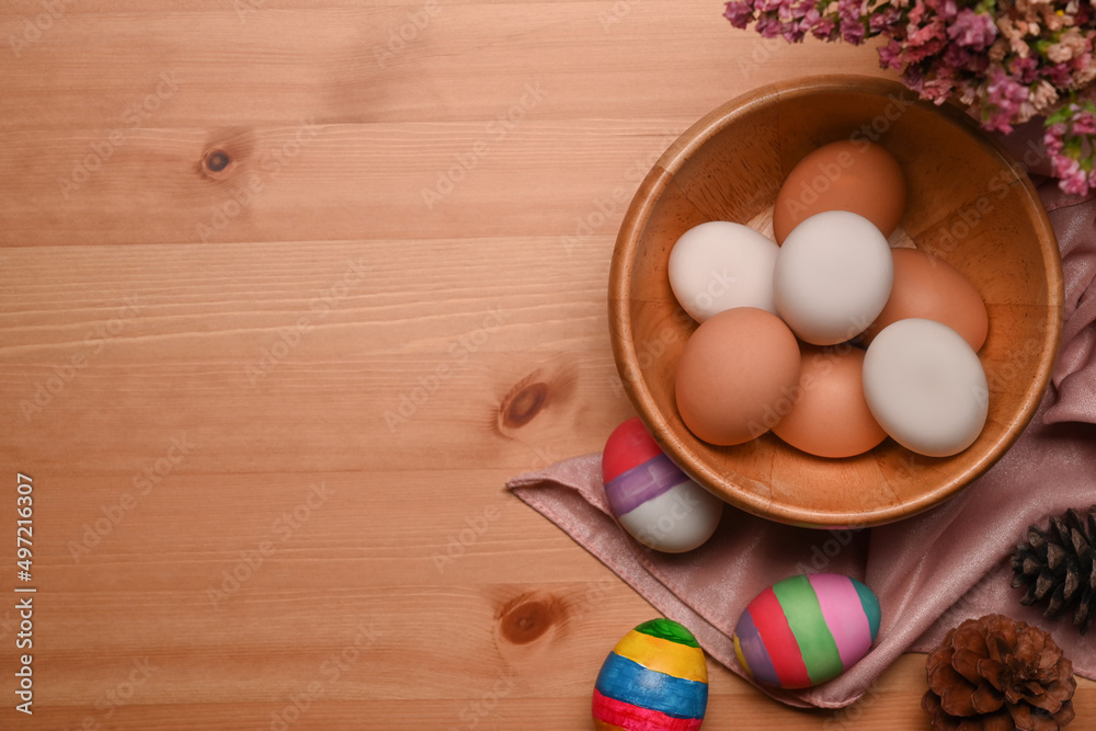 Painted Easter eggs with spring flowers on wooden background. Happy Easter concept. Painted Easter eggs with spring flowers on wooden background. Happy Easter concept.