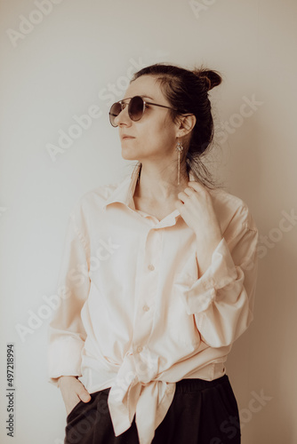 Young woman posing in sunglasses.