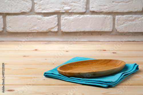 Cutting board with cotton napkin on wooden table